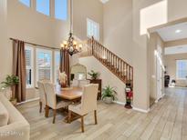 Elegant dining room with chandelier and adjacent living space at 27486 N 89Th Dr, Peoria, AZ 85383