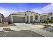 Charming single-story home featuring desert landscaping, a two-car garage, and a welcoming front porch at 40015 W Crane Dr, Maricopa, AZ 85138