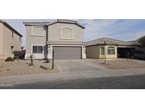 Two-story house with gray exterior, two-car garage, and desert landscaping at 40092 W Hayden Dr, Maricopa, AZ 85138