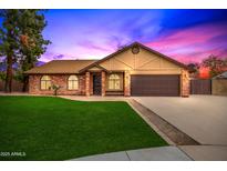 Brick ranch home with 2-car garage and well-manicured lawn at 4343 E Downing St, Mesa, AZ 85205