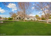 Spacious front yard with lush lawn and mature trees at 2090 E Coconino Ct, Gilbert, AZ 85298