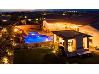 Luxury backyard oasis featuring a sparkling pool, spa, and outdoor kitchen at 14959 S 184Th Ave, Goodyear, AZ 85338