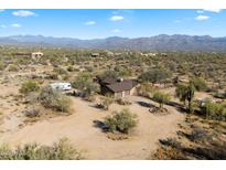 Aerial view of a single-story home on a large desert lot with mountain views at 30247 N 164Th St, Scottsdale, AZ 85262