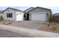 Charming home with a two-car garage, a one-car garage, and a paved driveway, offering ample parking space at 3909 E Gold Mountain Ave, San Tan Valley, AZ 85143
