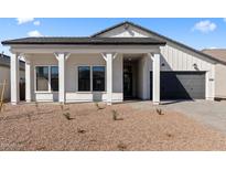 Inviting exterior showcasing a covered porch with stylish support columns and a meticulously maintained gravel yard at 42140 N Golden Trl, San Tan Valley, AZ 85140