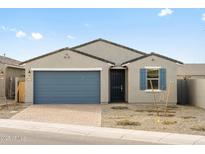 Charming single-story home with a blue garage door, neutral exterior, and a nicely paved driveway at 8637 W Warner St, Tolleson, AZ 85353