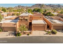 Aerial view of a two-story home with a tile roof and a mountain backdrop at 10653 N 10Th Pl, Phoenix, AZ 85020