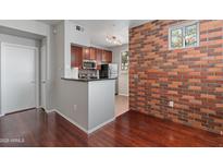 Modern kitchen with stainless steel appliances and dark wood cabinets at 3302 N 7Th St # 226, Phoenix, AZ 85014