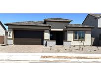 Charming single-story home with a well-maintained front yard and a two-car garage at 43513 N Wollemi St, Queen Creek, AZ 85140