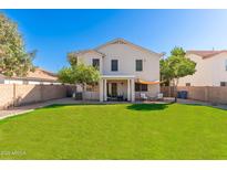 Spacious backyard with lush green grass and a covered patio perfect for outdoor entertaining and relaxation at 4660 E Torrey Pines Ln, Chandler, AZ 85249