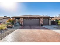 Brick ranch home with 2-car garage and landscaped front yard at 26434 S Hogan Dr, Sun Lakes, AZ 85248
