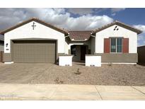 Charming single-story home featuring a neutral-colored stucco finish, tile roofing, and an attached two-car garage at 43429 N Wollemi St, Queen Creek, AZ 85140