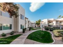 Complex exterior showing manicured landscaping and walkways at 1825 W Ray Rd # 2060, Chandler, AZ 85224