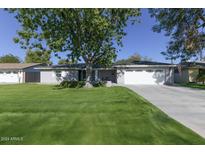 Ranch style home with spacious lawn and attached garage at 4034 E Osborn Rd, Phoenix, AZ 85018