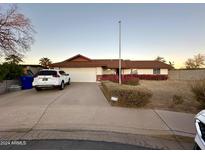 Ranch style home with driveway, landscaping, and a two-car garage at 749 S Rico Cir, Mesa, AZ 85204