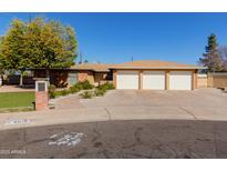 Brick house with three-car garage and landscaped front yard at 4616 W Lane Ave, Glendale, AZ 85301