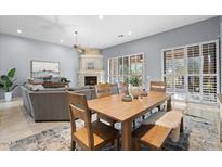 Bright dining area with wood table and chairs, adjacent to living room at 13300 E Via Linda -- # 1042, Scottsdale, AZ 85259