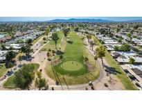 Stunning aerial view of the golf course, surrounded by homes in the community at 10214 E Michigan Ave, Sun Lakes, AZ 85248