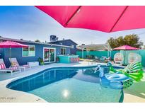 Inviting backyard oasis with a sparkling pool, patio, and vibrant landscaping at 602 E Taylor St, Tempe, AZ 85288