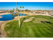 Aerial view of the golf course community with a lake and houses at 9048 E Cedar Waxwing Dr, Sun Lakes, AZ 85248