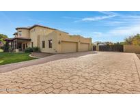 Spacious three-car garage with a stamped concrete driveway at 2697 E Via Del Arboles --, Gilbert, AZ 85298
