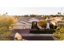 Beautiful home with a three-car garage and manicured lawn at 4516 S Jojoba Way, Chandler, AZ 85248
