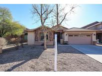 Single-story home with stone accents and a two-car garage at 7165 W Fleetwood Ln, Glendale, AZ 85303