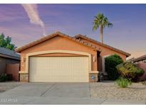 Single-story house with two-car garage and desert landscaping at 8724 E Nopal Cir, Mesa, AZ 85209