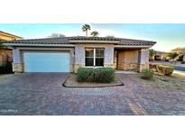 One-story home with brick facade and landscaped front yard at 13613 W Cypress St, Goodyear, AZ 85395