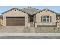 Charming single-story home featuring desert landscaping and a private gated front entry at 17648 W Pierson St, Goodyear, AZ 85395
