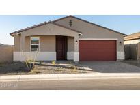 Charming single-story home with a red garage door and desert landscaping, perfect for low-maintenance living at 17743 W Elm St, Goodyear, AZ 85395