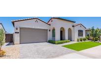 Charming single-story home features a neutral color palette, tile roof, arched entryway, and a well-maintained front yard at 11899 N Spearfish St, Surprise, AZ 85388