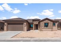 Charming single-story home with a stone facade, tile roof, and a spacious two-car garage at 7736 W Mockingbird Way, Florence, AZ 85132
