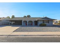 Ranch style home with carport and gravel driveway at 11452 N 109Th Ave, Sun City, AZ 85351