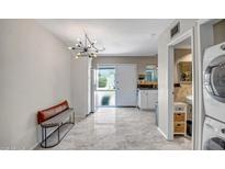 Bright kitchen features stainless appliances, tile floors, and a unique chandelier lighting fixture at 4600 N 68Th St # 313, Scottsdale, AZ 85251