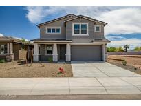 Charming two-story home with a large driveway and well-maintained gravel landscaping at 5534 W Banff Ln, Glendale, AZ 85306