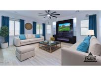 Bright living room featuring modern fireplace, plush sofas, and stylish decor, perfect for relaxation and entertaining at 1270 E Baranca Rd, Gilbert, AZ 85297