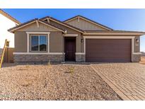 Single-story home with brown garage door and stone accents at 21615 N Daniel Dr, Maricopa, AZ 85138
