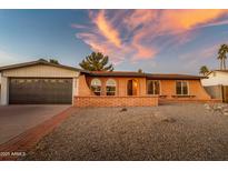 Brick ranch house with a 2-car garage and landscaped front yard at 2804 W Curry St, Chandler, AZ 85224