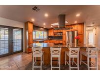 Kitchen with granite island, stainless steel appliances, and access to backyard at 2804 W Curry St, Chandler, AZ 85224