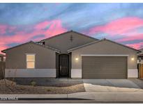 Charming single-Gathering home featuring a two-car garage and desert landscaping at 37013 W La Paz St, Maricopa, AZ 85138
