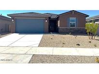 Charming single-story home featuring low maintenance desert landscaping and a convenient two-car garage at 22507 W Pontiac Dr, Surprise, AZ 85387