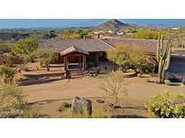 Stunning aerial view of a luxurious home with a large yard and mountain backdrop at 8505 E Morning Vista Rd, Scottsdale, AZ 85266