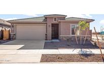 Single-story house with a two-car garage and well-manicured landscaping at 17867 W Encinas Ln, Goodyear, AZ 85338