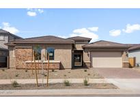 Beautiful single-story home featuring a brick facade, tiled roof, and a well-manicured front yard at 22500 E Orchard Ln, Queen Creek, AZ 85142