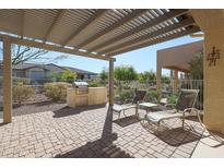 Relaxing patio with built-in grill and pergola at 17547 W Silver Fox Way, Goodyear, AZ 85338