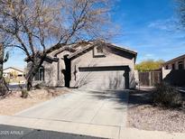 Charming single-story home with a well-manicured front yard and a spacious two-car garage with an extended driveway at 3055 N Red Mountain Mtn # 95, Mesa, AZ 85207