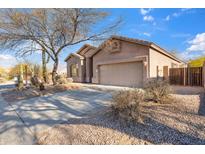 Single story home featuring a well-maintained landscaped yard, private fence, and a two-car garage at 3055 N Red Mountain Mtn # 95, Mesa, AZ 85207