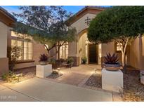 Elegant home exterior with landscaped courtyard, inviting entryway, and charming architectural details at 41348 N Congressional Dr, Anthem, AZ 85086