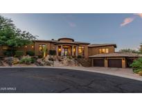 Stunning single-story home with porte-cochere, mature desert landscaping, and three-car garage at 10742 E Greythorn Dr, Scottsdale, AZ 85262